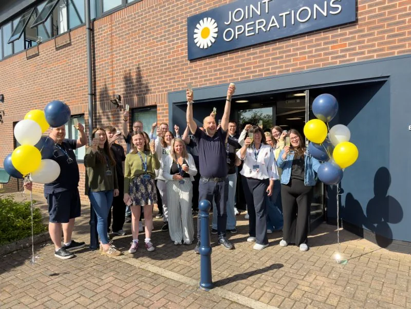 The Joint Operations team celebrating outside the Joint Operations building